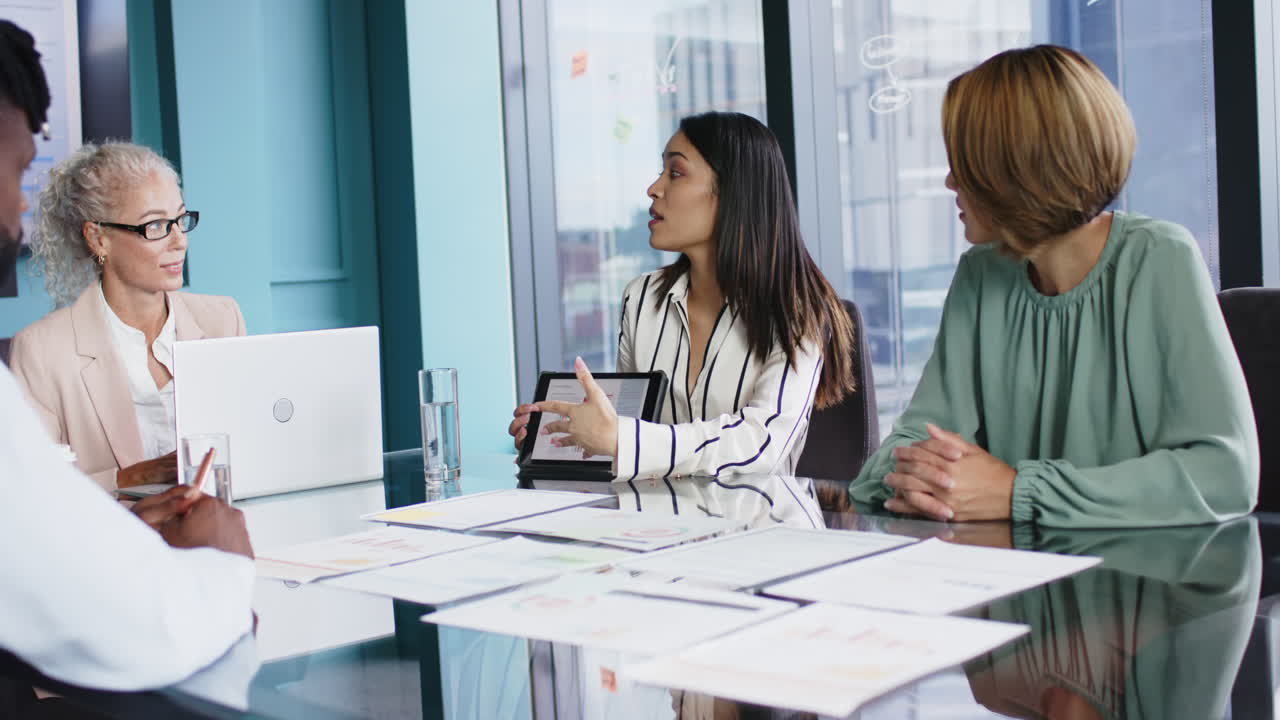 Business meeting, women discussing project with documents and laptop in office