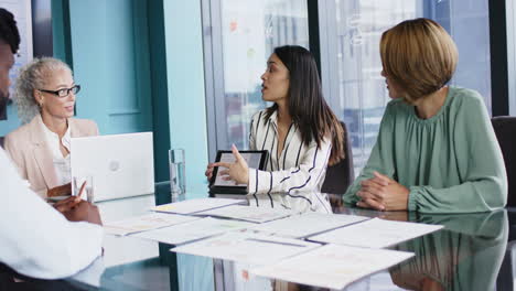 business meeting, women discussing project with documents and laptop in office