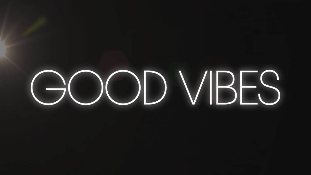 Animation of glowing Good Vibes text on dark background with light flare
