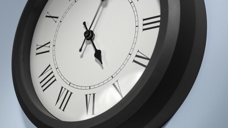 Latin Clock Face on Light Blue Wall in Time Lapse