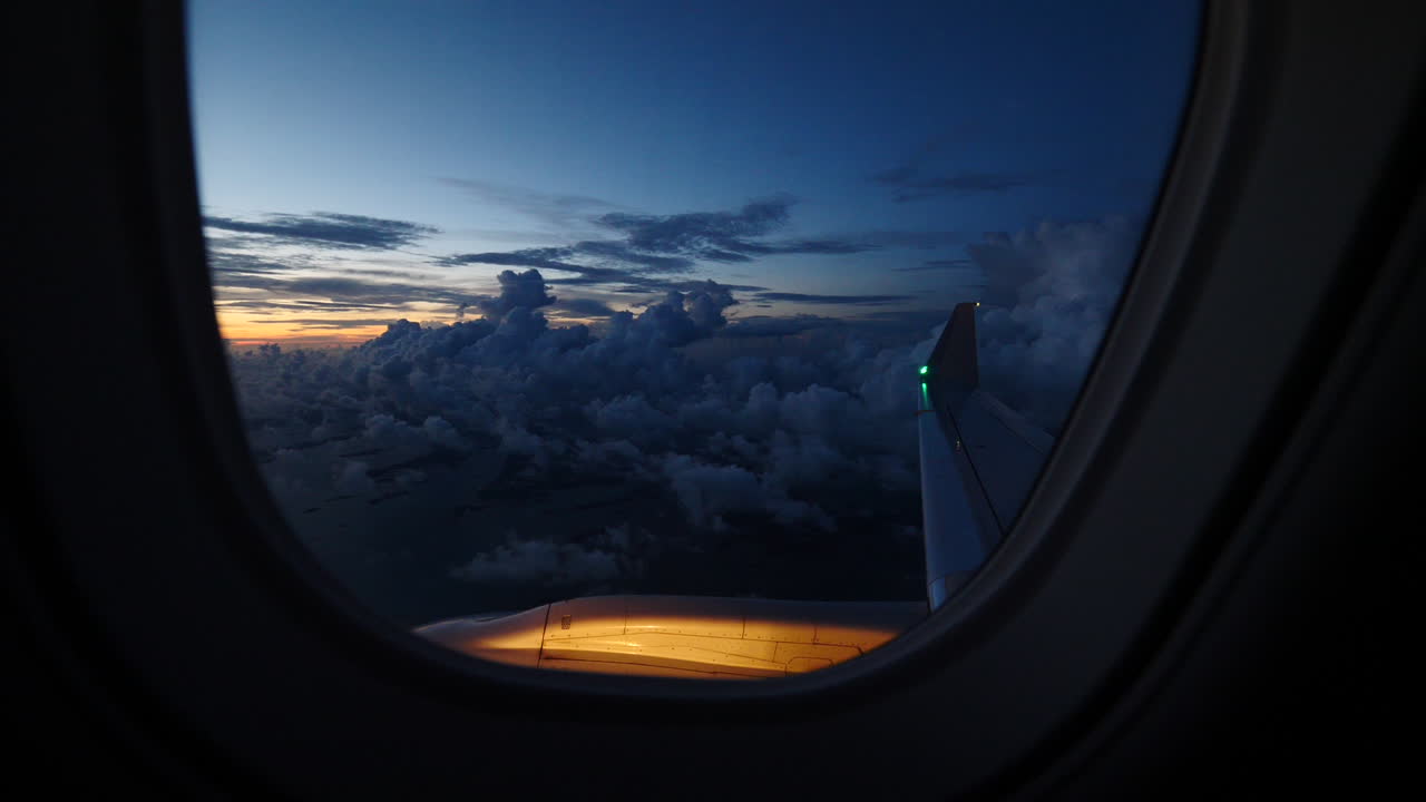 Slow motion sunset through passenger airliner window seat