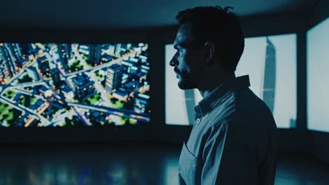 man observing a digital city model on screen