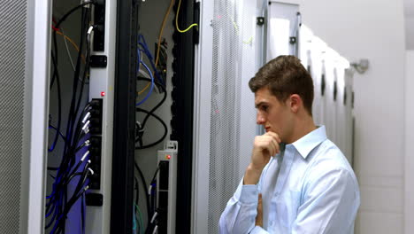 Technician-looking-at-open-server-locker