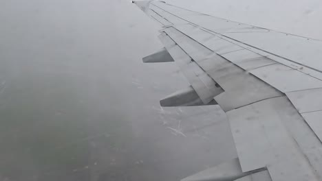 airplane flying from dublin airport in ireland on rainy day