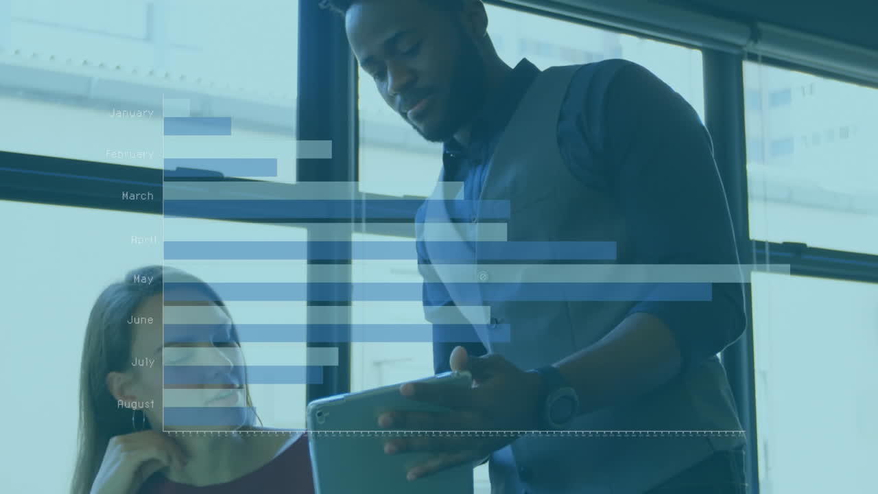 Animation of graph with month names over diverse coworkers discussing on desk in office