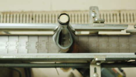 Wine-Bottles-Closed-With-A-Cork-Stopper-Move-Along-The-Conveyor-Belt-View-From-Above