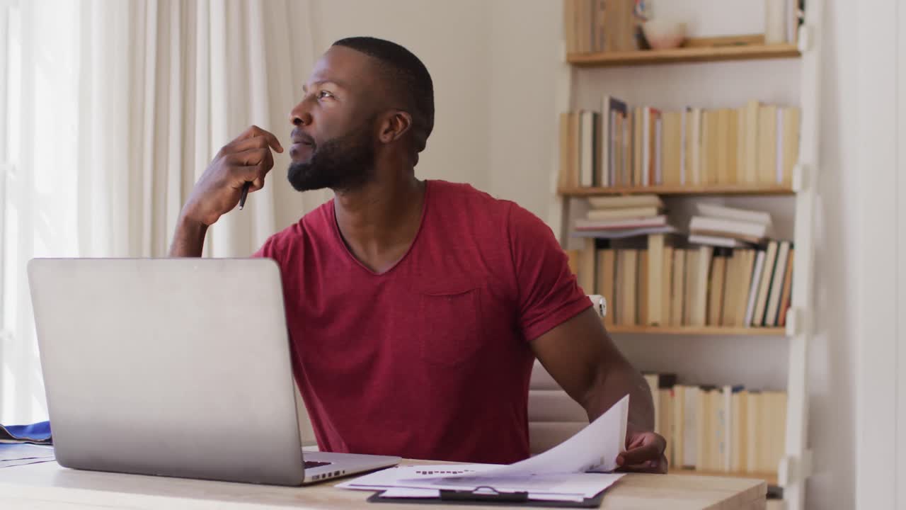 Thoughtful african american man reading documents