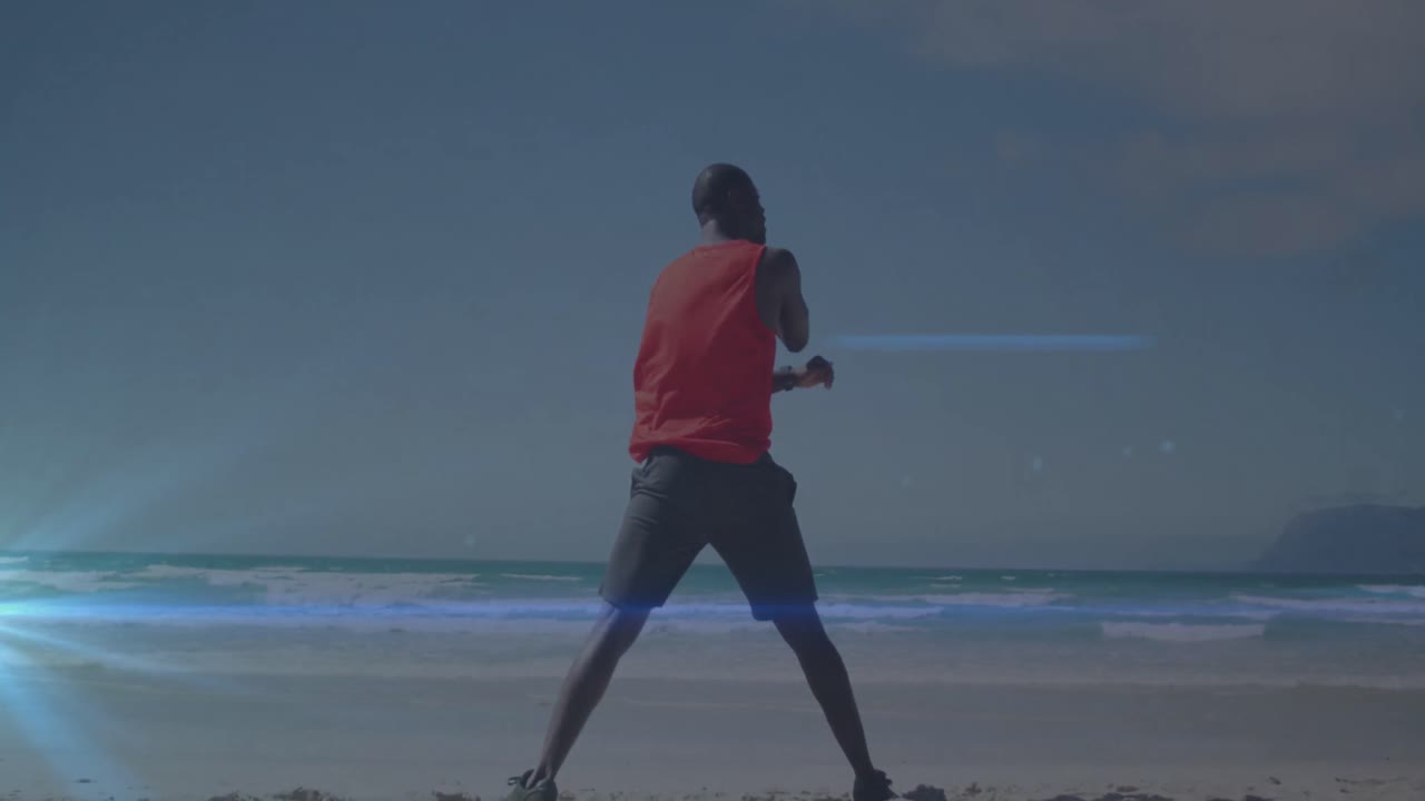 Animation of blue light spot against rear view of african american fit man stretching at the beach
