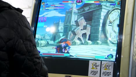 person playing a retro arcade fighting game