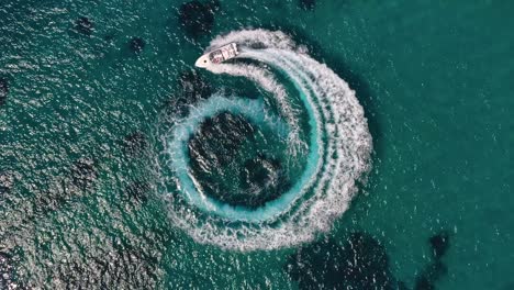 aerial view of two motorboats forming a circle of waves