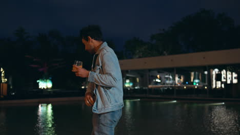 chilling guy walking late evening at water pool. handsome italian man relaxing