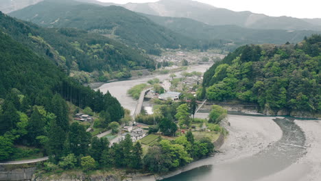 aerial view of lush green mountains and river of kawane in shizuoka, japan - drone forward