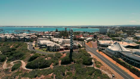 bunbury lighthouse with surrounding coastal neighborhoods and beach in australia, aerial orbital view