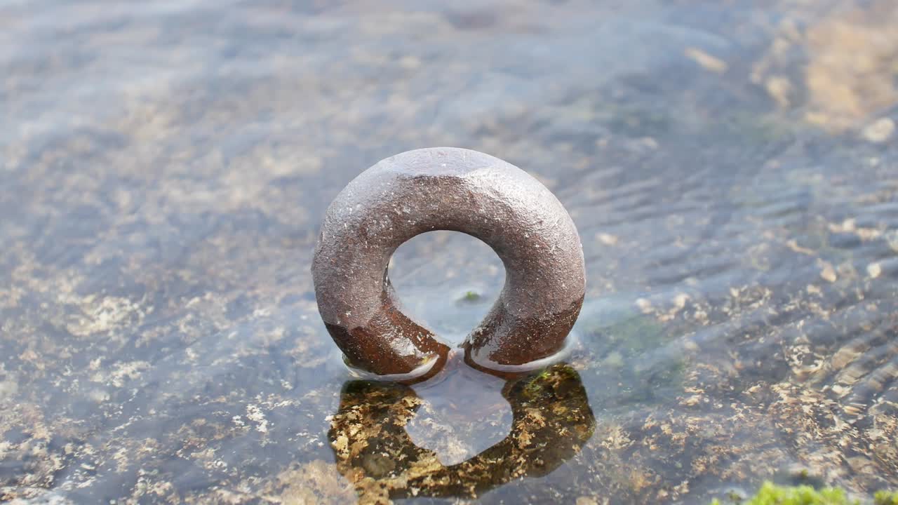 Old mooring ring on shore
