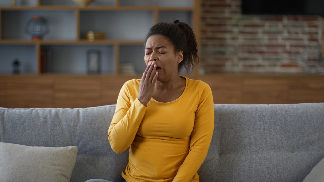 Woman Yawning on a Couch