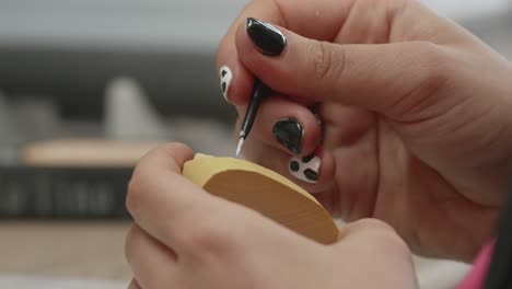 Dentist-with-painted-nails-painting-teeth