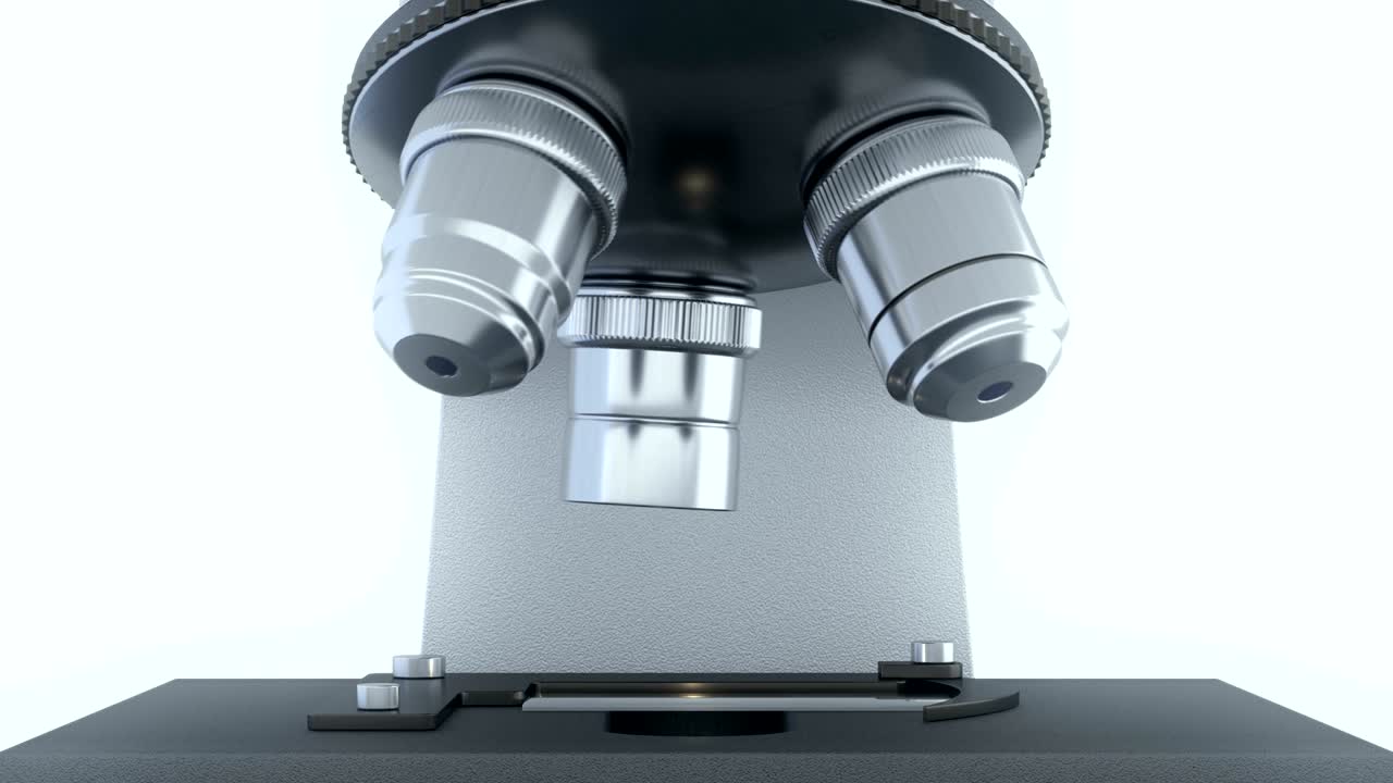 Laboratory microscope in bright white laboratory rotating its metal lenses