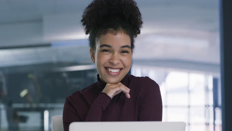 happy black woman working on laptop