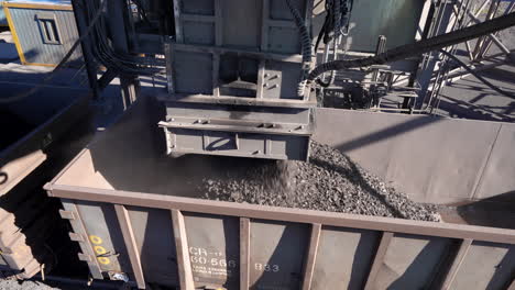 a rapid loading system loads manganese ore into a rail wagon on a mine