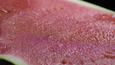 watermelon pulp gyrating on black background