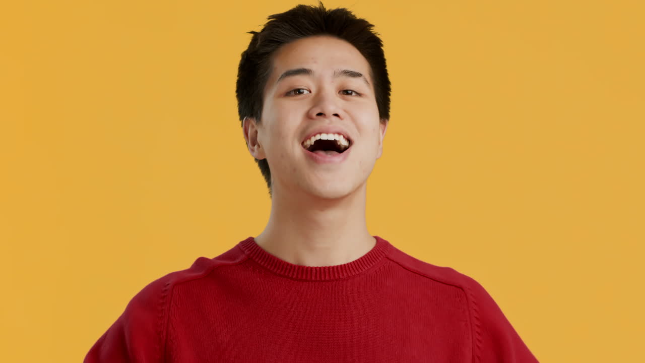 Smiling Young Man Pointing at Himself