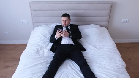 office worker lying on bed after working week office worker lying on bed after working week migraine and fatigue in a man depression