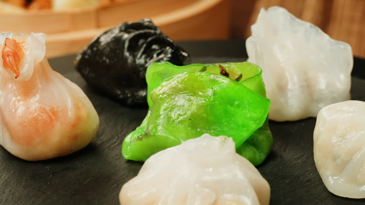 Close-up of Various Steamed Dim Sum Dumplings Rotating on a Plate