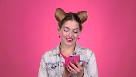 woman using a pink smartphone