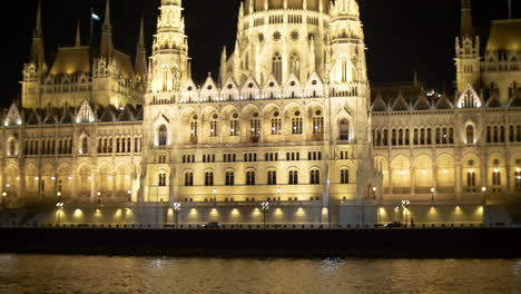 View-to-Hungarian-Parliament-at-night-from-Danube-river,-Budapest,-Hungary