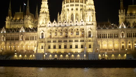 view to hungarian parliament at night from danube river, budapest, hungary