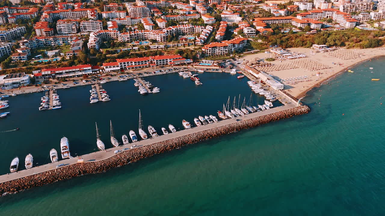Beautiful resort area with sandy beach and yacht club. Modern hotels with orange roofs at backdrop. Sveti Vlas, Bulgaria