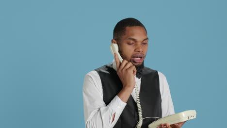 bellboy concierge staff answering landline phone call to make reservations