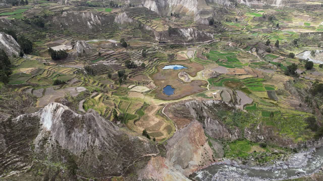 Flyover Rio Colca and terraced agriculture fields in rugged south Peru