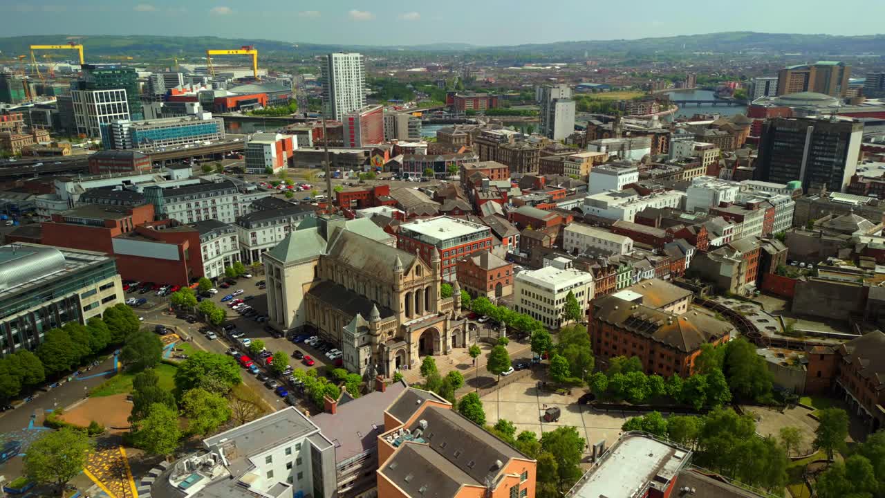 Ultra-wide, advancing aerial video of St Anne's Cathedral in the Cathedral Quarter in Belfat City Centre, Northern Ireland on a bright and sunny day. Filmed in 4K, 60FPS and with Rec709 Color.