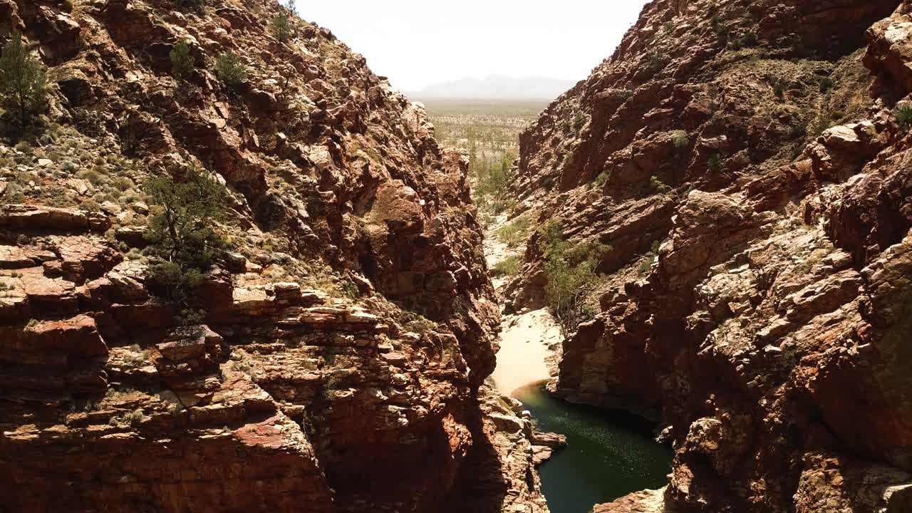 Kings Canyon waterhole, drone descending into gorge Northern Territory Australia