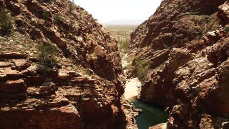 kings canyon waterhole, drone descending into gorge northern territory australia