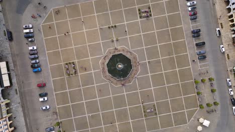 Fountain-in-center-Amazing-aerial-top-view-flight-Budweis-Budejovice-old-town-in-Czech-Republic,-summer-of-2023