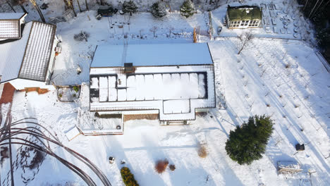 drone hyperlapse of the sun melting, snowy solar cells on a house, winter day