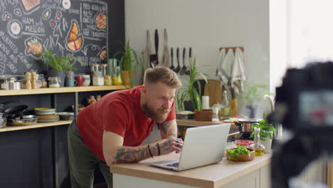 food blogger video calling on laptop in kitchen