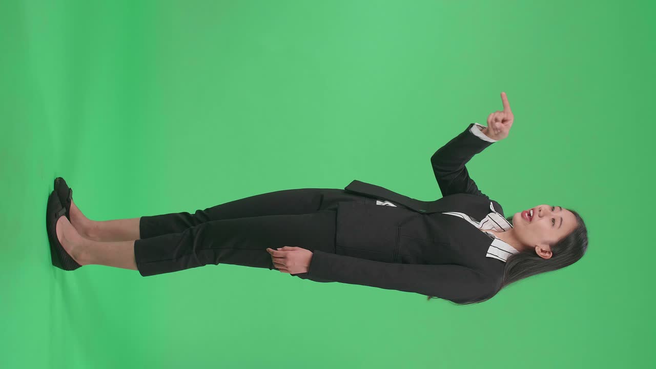 Full Side View Body Of An Angry Asian Business Woman Scolding While Standing On Green Screen In The Studio