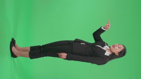 full side view body of an angry asian business woman scolding while standing on green screen in the studio
