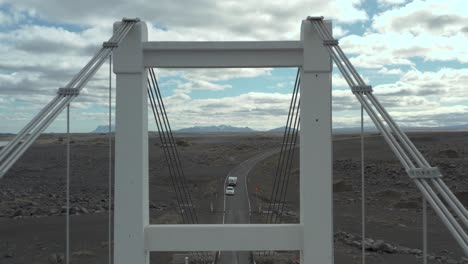 flying through steel tower of remote suspension bridge in iceland, aerial