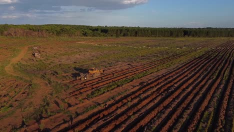 aerial drone shot of soil prepartion machine preparing agriculture land in posadas of misiones argentina