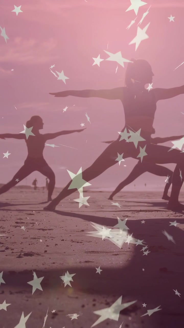 Vertical video: Two women practicing yoga at beach low sun making star overlay drifting over forms