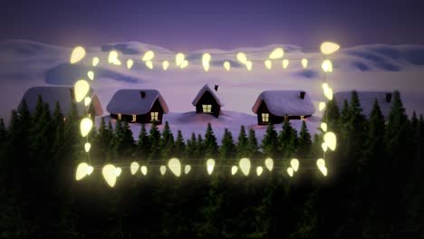 Yellow-glowing-decorative-fairy-lights-against-winter-landscape-with-houses-and-trees