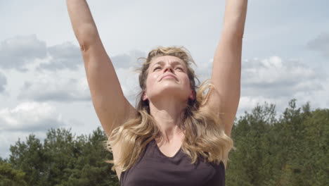 close up of woman reaching to the sky