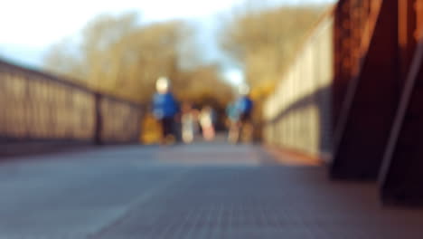 Man-riding-bike-on-bridge