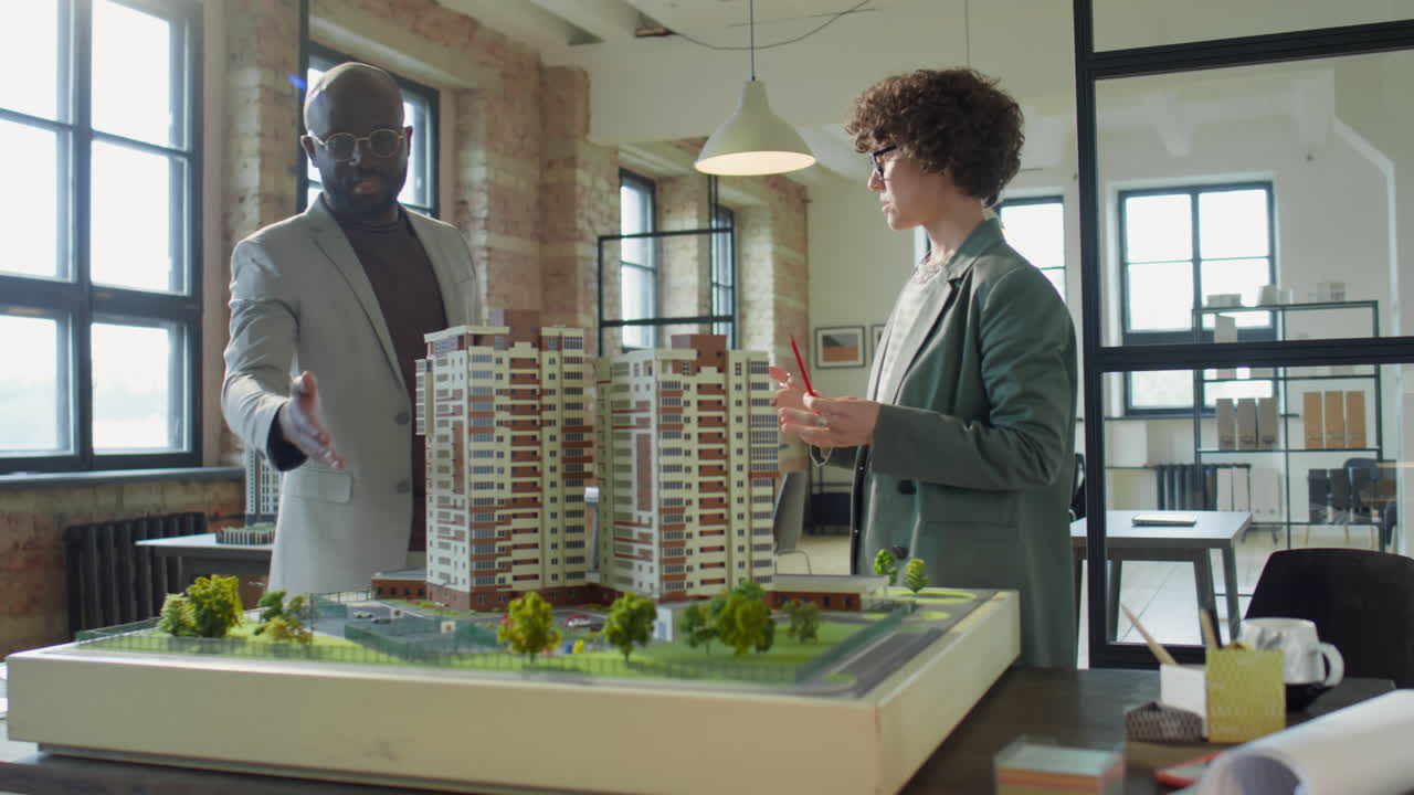 Architects or Developers Discussing a Large-Scale Architectural Model in an Office