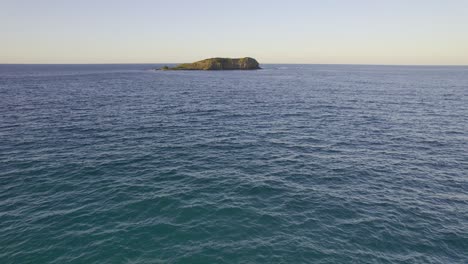 Cook-Island-Surrounded-By-Calm-Blue-Sea-During-Sunrise