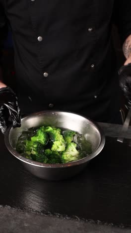 chef washing broccoli in ice bath